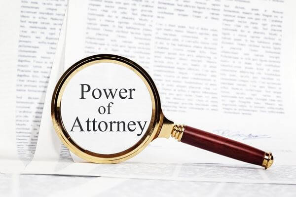 Magnifying glass that says "power of attorney" 