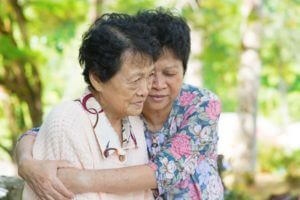 elderly women hugging