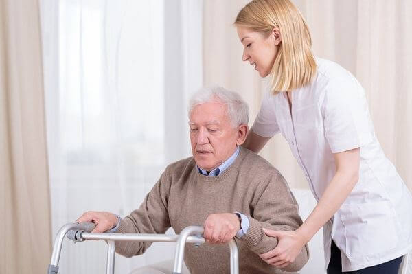 Nurse helping an elderly man