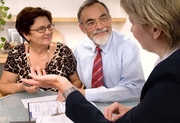 Older couple speaking to a lawyer